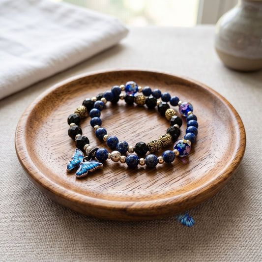 Blue Lapis bracelet displayed on a wooden jewelry dish with natural light and neutral background.